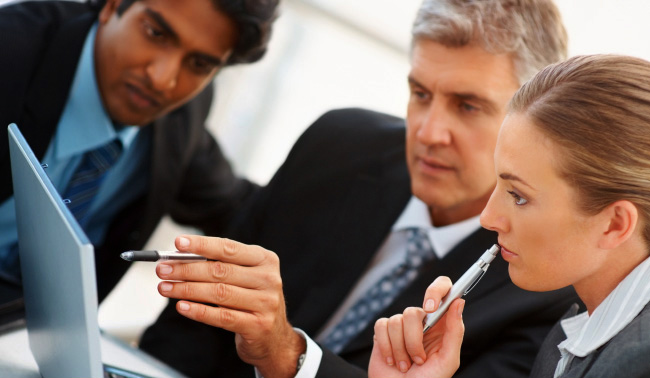 Employers looking at a computer.